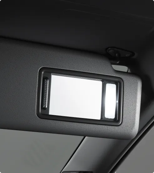 Driver and passenger side sun visor with ticket holder and illuminated vanity mirror